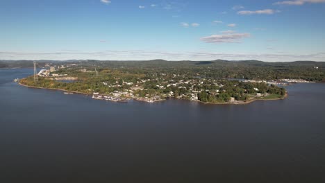 An-aerial-view-over-the-Hudson-River-facing-Verplanck,-NY-on-a-beautiful-day-with-blue-skies