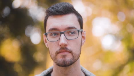 Confused-disturbed-young-man-with-glasses-closeup-portrait