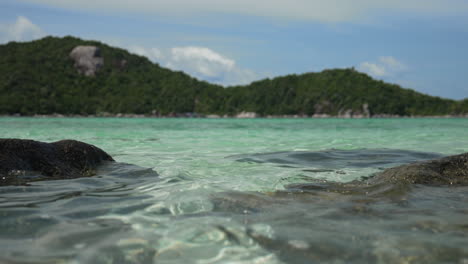 Crystal-Clear-Water-Beautiful-Island-with-Rocks,-Natural-Tropical-Beach,-Right-Pan-Cinematic-Shot