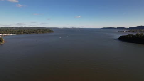 An-aerial-view-high-over-the-Hudson-River-in-upstate-NY-in-the-fall-season-on-a-beautiful-day-with-blue-skies