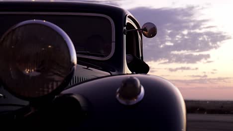 Close-Up-Shot-Of-Unique-Vintage-Car,-Driver-Waiting-For-Bride-And-Groom-At-Wedding-sunset