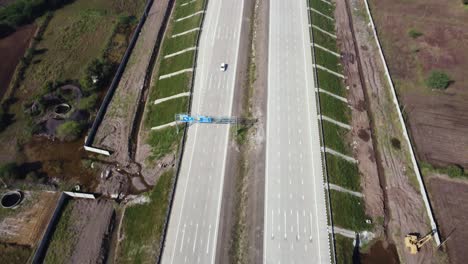 Tilting-down-aerial-drone-shot-of-a-car-on-Samruddhi-Mahamarg-or-Nagpur-to-Mumbai-Super-Communication-Expressway-now-opened-for-public