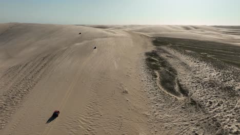 Aerial-Drone-Shot-of-Trucks-Driving-On-Dunes-in-North-Eastern-Brazil