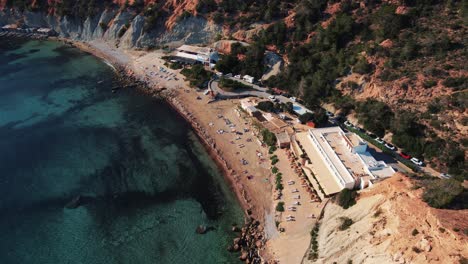 Aerial-over-touristic-beach-in-Isla-de-es-Vedrà,-Spain