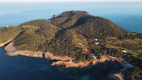 remote-mountain-island-Pou-D'es-Lleo,-Ibiza-descending-aerial