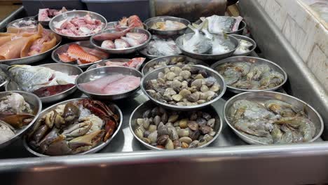 Freshness-of-raw-seafood-displays-neatly-on-the-steel-plates-in-the-market-in-Singapore