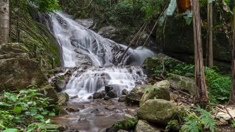 Silky-waterfall-time-lapse-in-lush-jungle,-wide