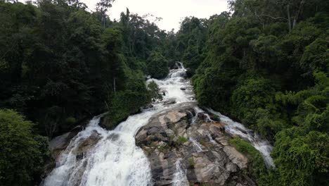Push-in-aerial-view-over-top-of-Waterfall-in-Lush-Jungle