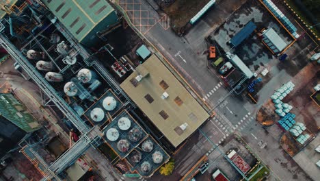 Industrial-plant-with-a-futuristic-looking-theme,-aerial-drone-footage,-with-a-steampunk-look-with-industrial-buildings-and-vehicles