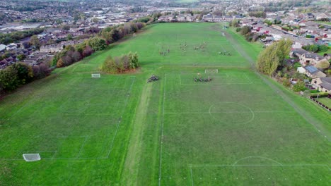 Drone-video-footage-of-extensive-playing-fields-situated-on-the-summit-of-a-hill