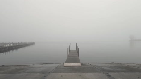 Low-and-slow-push-over-a-dock-on-a-misty-lake