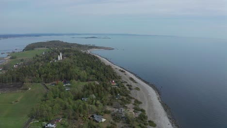Aerial-of-the-Jomfruland-Lighthouse-It-is-a-coastal-lighthouse-located-on-the-island-of-Jomfruland-in-Kragerø,-Norway