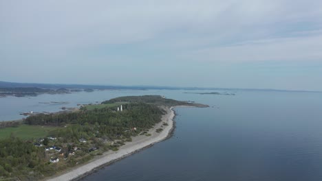 Aerial-of-the-Jomfruland-Lighthouse-It-is-a-coastal-lighthouse-located-on-the-island-of-Jomfruland-in-Kragerø,-Norway
