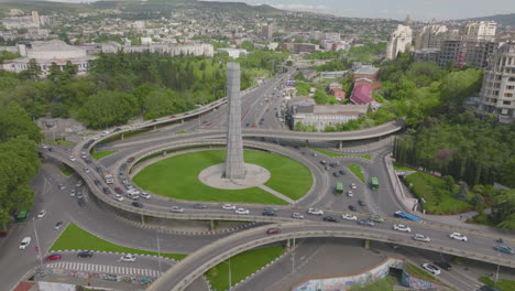 Aerial-shot-of-a-busy-junction-with-cars-filtering-onto-a-highway
