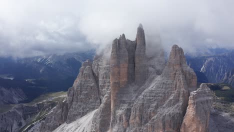 Aerial-view-of-Tre-Cime-di-Lavaredo-Mountain-covered-by-clouds-in-Dolomites