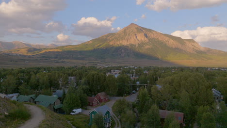 Aerial-landscape-of-Crested-Butte-neighborhood-and-mountain-beyond-at-golden-hour