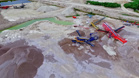 Sand-and-stone-industrial-mining-quarry---aerial-parallax-orbiting-view
