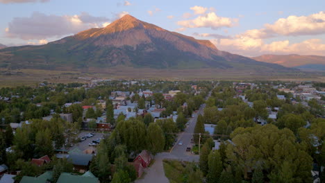 Aerial-view-of-Crested-Butte-trucking-right-over-the-houses-and-streets-of-the-Colorado-town-with-the-mountain-on-the-horizon