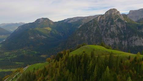 Flying-over-dense-Karwendel-alpine-park-valley-towards-extreme-rocky-Tyrol-mountain-range