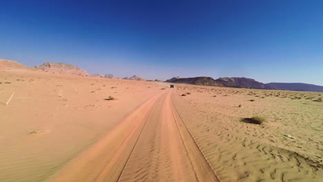 Car-rear-POV-driving-in-the-desert-and-being-chased-by-other-SUVs