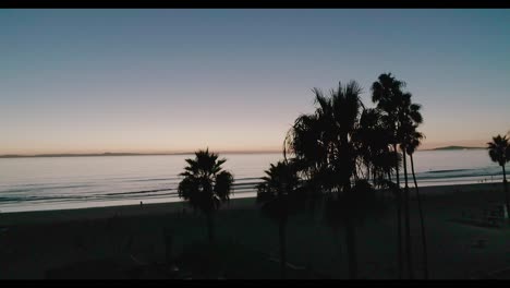 Newport-Beach-California-aerial-footage-featuring-the-pier,-beach,-water,-surfing,-swimming,-and-beach-goers