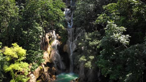 4k-pan-out-of-the-main-waterfall-at-the-famous-multi-level-Kuang-Si-falls-in-Laos,-Southeast-Asia