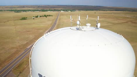 Drone-view-of-cellular-signal-transmitter-mounted-on-top-of-a-water-tower