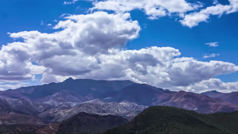 Time-lapse-of-clouds-moving-over-mahogany-colored-mountains