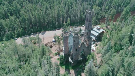Drone-view-of-a-castle-style-building-in-the-middle-of-the-forest-in-Colorado