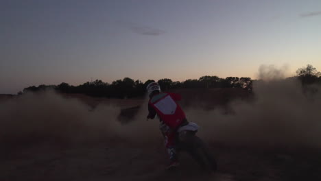 A-motocross-rider-spins-out-a-dirt-cloud,-spitting-dirt-and-dust-in-all-directions
