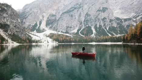 Aerial-Footage-of-boat-in-a-lake-in-the-middle-of-woods