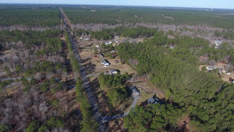 Drone-shot-moving-towards-a-row-of-homes-settled-on-a-back-road-in-North-Carolina