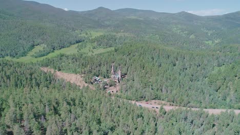 Drone-view-of-the-forest-in-the-middle-of-Colorado's-forest-with-some-buildings-in-the-middle