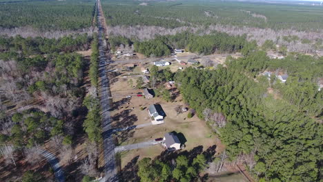 Drone-shot-moving-down-a-back-road-surrounded-by-a-forest-in-North-Carolina