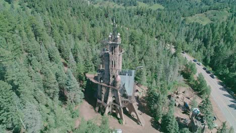 Drone-view-of-a-castle-like-building-in-the-middle-of-tress-in-Colorado