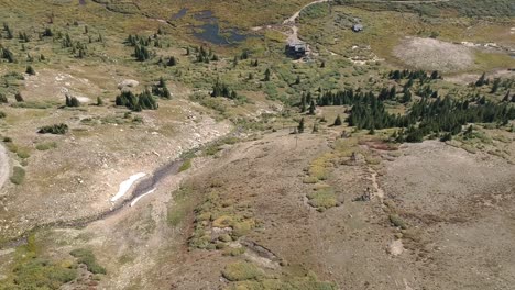 Aerial-views-of-Mosquito-Pass-in-Colorado-showing-fall-colors-on-large-meadows-with-touches-of-water-and-snow