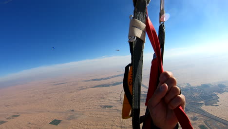 Skydiver-parachuting-over-the-desert-dunes