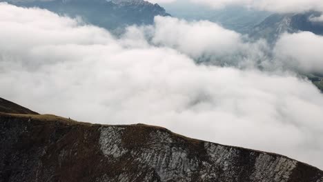 Drone-reveal-shot-over-summits-above-a-sea-of-fog-4k