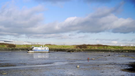 Mud-flats-with-blue-skies-and-old-boat