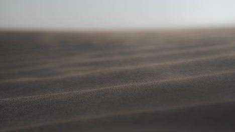 Closeup-of-sand-blowing-in-middle-eastern-desert-in-the-UAE