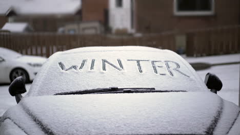 Winter-written-on-snowy-car-windscreen
