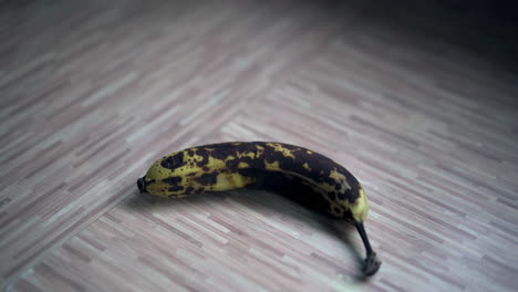 Banana-over-ripe-yellow-then-black-on-wooden-counter-top