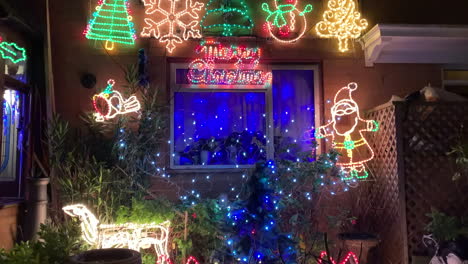 Tilt-up-shot-of-Christmas-lights-outside-a-London-home-at-night
