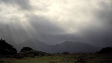 Irish-mountain-range-with-rolling-clouds-and-sun-rays-breaking-through-in-Mourne-country,-ideal-walking-trip