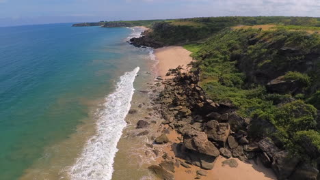 An-aerial-shot-over-the-pinks-sands-and-rocks-of-Playa-Rosada,-a-tropical-beach-near-Ayangue-on-the-Ruta-del-Spondylus-on-the-coast-of-Ecuador