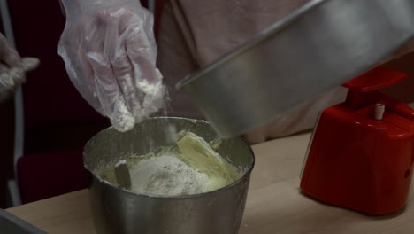 Pour-flour-into-a-mixture-of-biscuit-ingredients