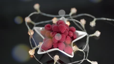 Beautiful-red-raspberries-in-star-dish-surrounded-by-star-lights-and-floating-orbs
