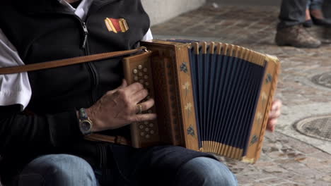 Musician-playing-with-accordion-in-public-area