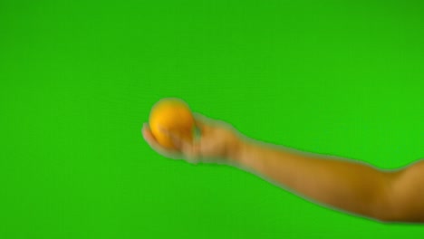 orange-with-green-background-throwing-up-orange-with-green-screen---green-background