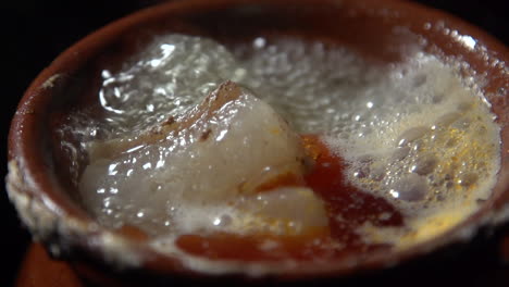 Slow-Motion-boiling-of-Cocido-madrileño,-traditional-chickpea-based-stew-from-Madrid,-Spain-in-a-Pot